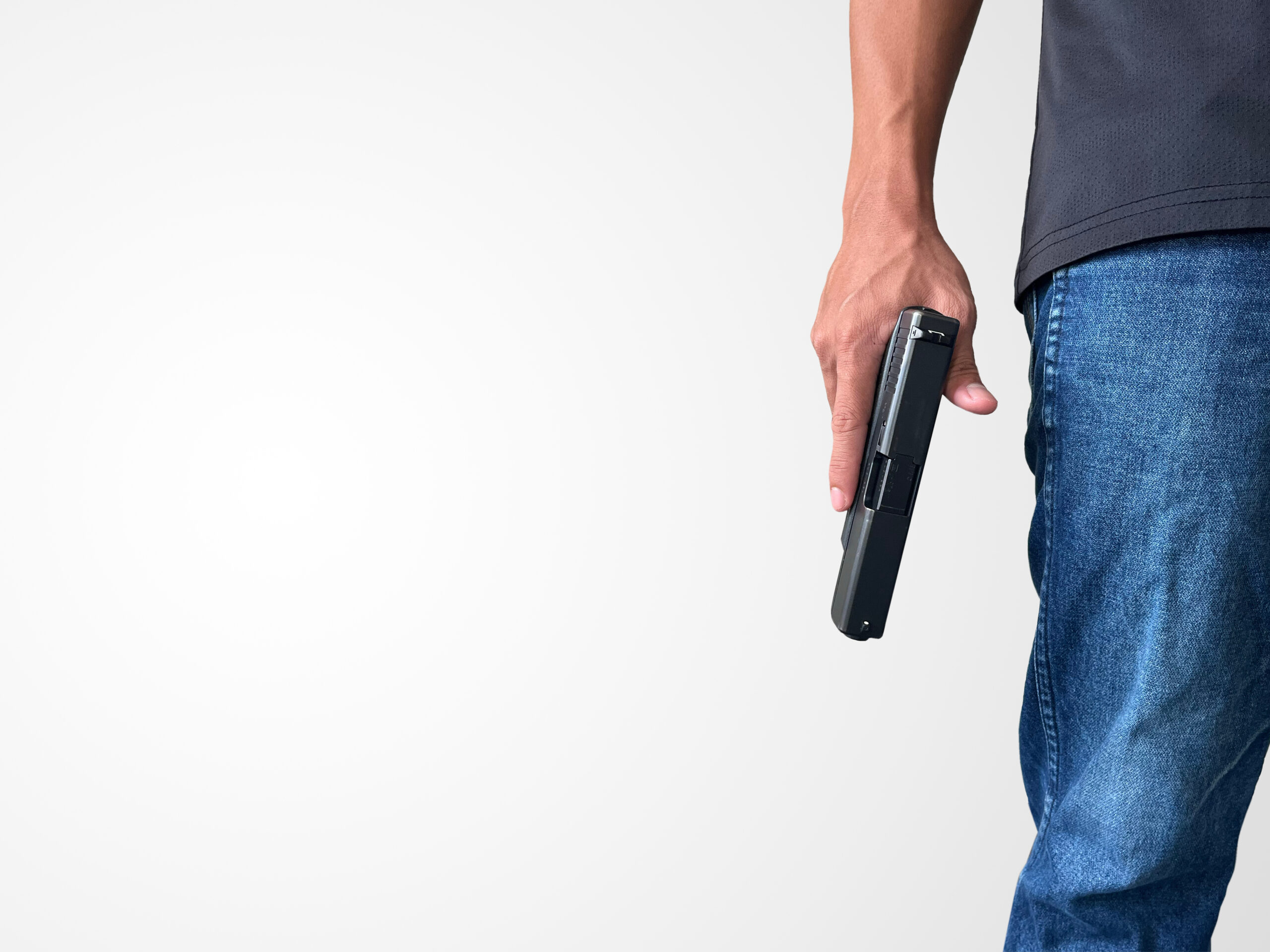 Person holding gun to the side of their body