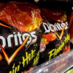 Kenwood High School's AI security system mistakenly flagged a student's Doritos bag as a firearm. Miscommunication among administrators following the alert led to a student being handcuffed. weapons detection, gun detection, Omnilert