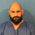 A Fenton High School security officer who was previously a police officer faces charges of home invasion, animal cruelty, drug possession, and more. Carmen Mirandola, Fenton High School District 100